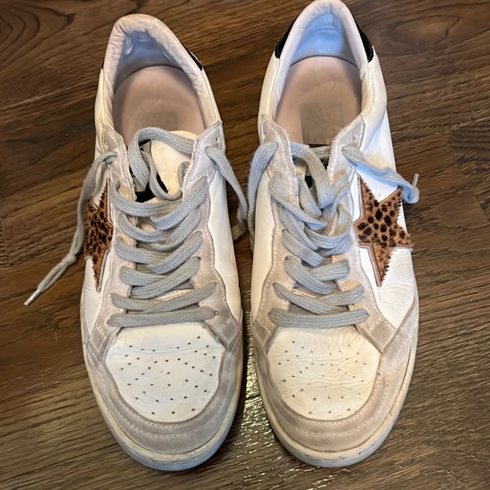 Distressed white golden goose sneakers with an animal print star